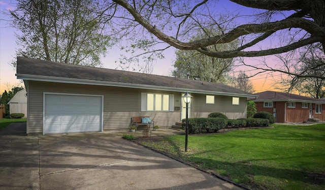 ranch-style house with concrete driveway, a front yard, and a garage