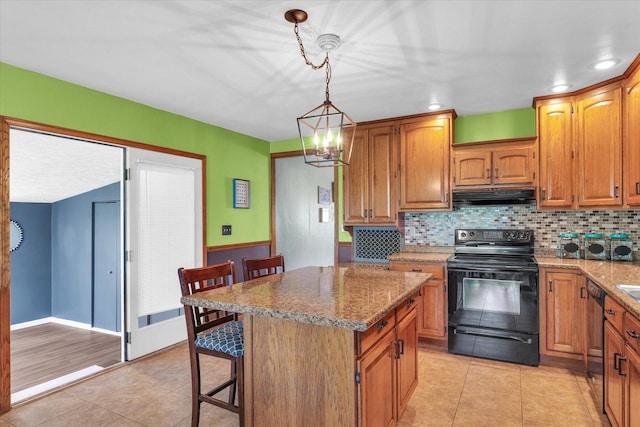 kitchen featuring dishwashing machine, under cabinet range hood, backsplash, light tile patterned floors, and electric range