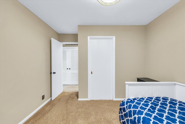 carpeted bedroom featuring baseboards