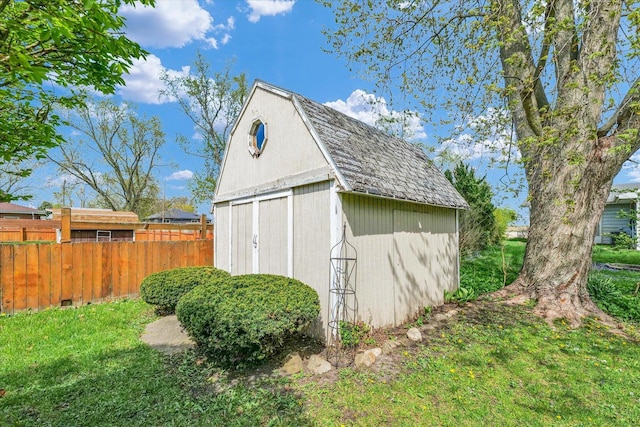 view of shed featuring fence