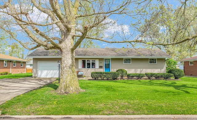 ranch-style house with an attached garage, a front lawn, and driveway