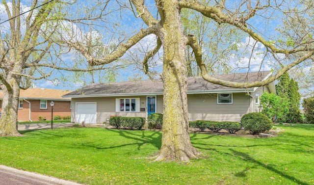 single story home featuring a front yard, a garage, and driveway