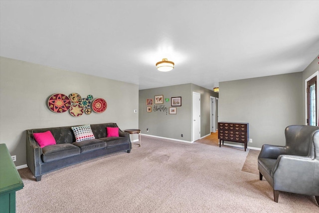 living area with baseboards and light colored carpet