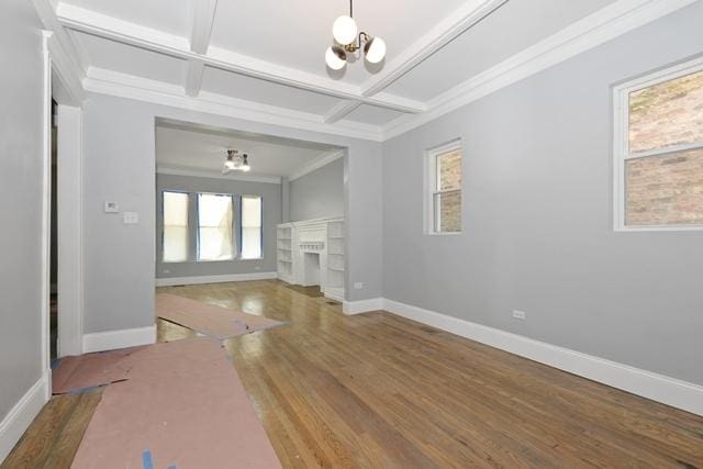 unfurnished living room featuring coffered ceiling, baseboards, a chandelier, and wood finished floors