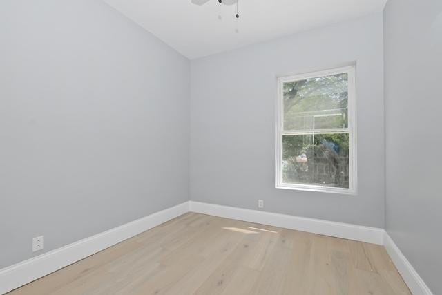 unfurnished room featuring baseboards, wood finished floors, and ceiling fan
