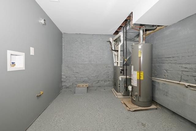 utility room with heating unit and gas water heater