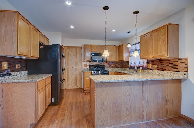 5615 Cider Grove Ct, Plainfield, IL 60586 - kitchen with black appliances, light wood-style floors, a peninsula, backsplash, and recessed lighting