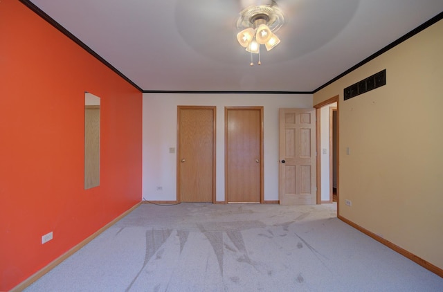 5615 Cider Grove Ct, Plainfield, IL 60586 - unfurnished bedroom with crown molding, two closets, light colored carpet, baseboards, and a ceiling fan