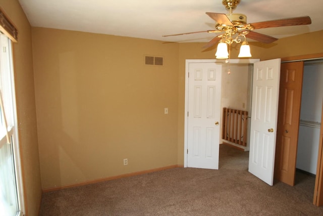 801 Heritage Dr, Mackinaw, IL 61755 - unfurnished bedroom with baseboards, visible vents, ceiling fan, and carpet flooring