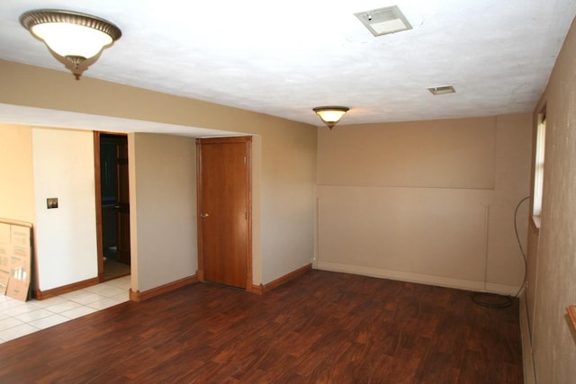 801 Heritage Dr, Mackinaw, IL 61755 - empty room with baseboards, visible vents, and wood finished floors