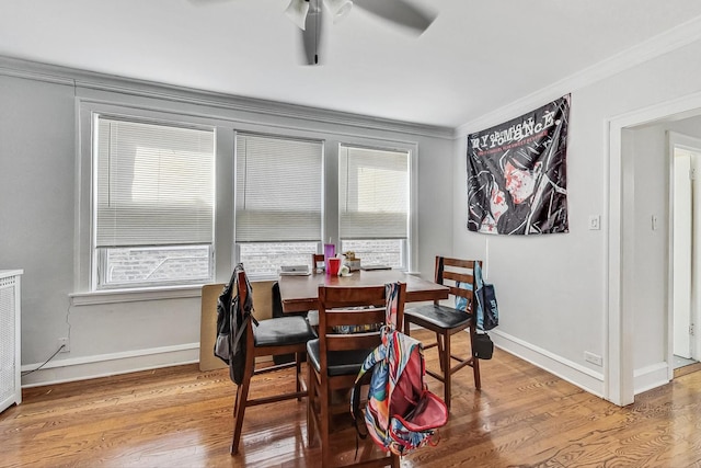 dining area featuring baseboards, wood finished floors, ceiling fan, and ornamental molding