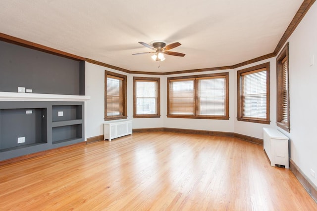 unfurnished living room featuring light wood finished floors, radiator, ornamental molding, and a ceiling fan