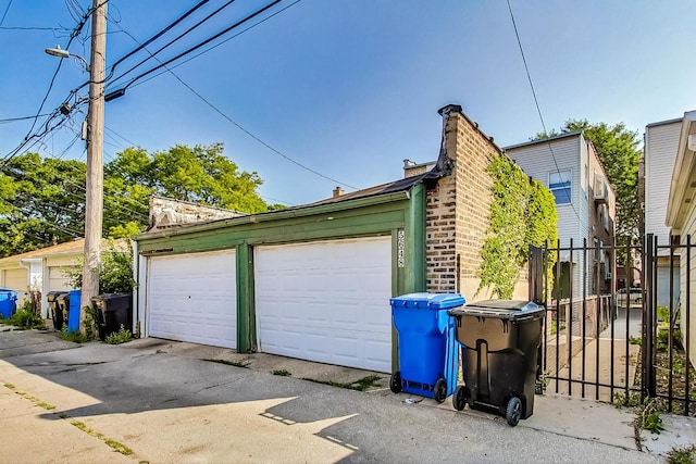 detached garage featuring fence