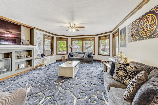 living room featuring ornamental molding, carpet, a textured ceiling, and ceiling fan