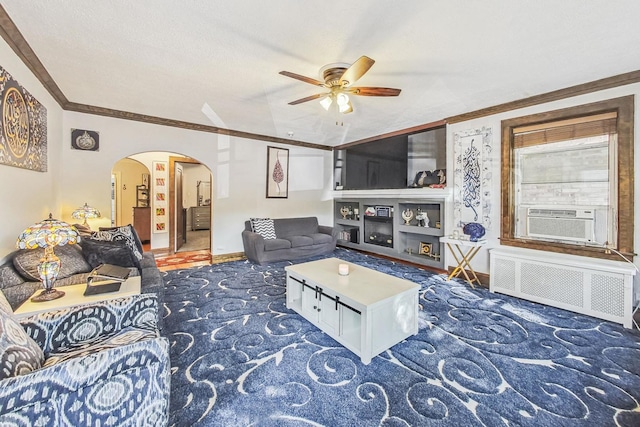carpeted living room featuring arched walkways, ceiling fan, crown molding, and radiator