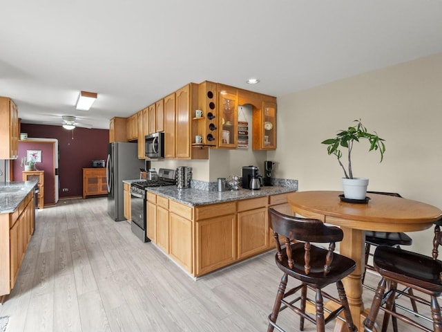 3721 Bunker Hill Dr, Algonquin, IL 60102 - kitchen with appliances with stainless steel finishes, light wood-type flooring, glass insert cabinets, and dark stone countertops