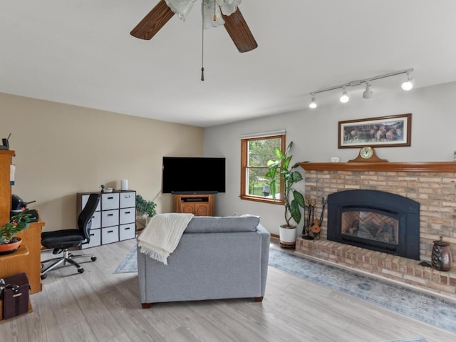 3721 Bunker Hill Dr, Algonquin, IL 60102 - living area with ceiling fan, wood finished floors, a fireplace, and track lighting