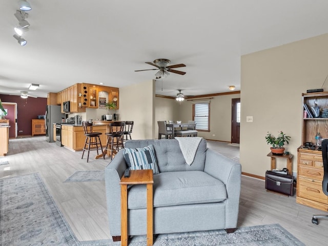 3721 Bunker Hill Dr, Algonquin, IL 60102 - living room featuring a ceiling fan, light wood-style flooring, and baseboards