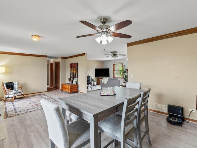 3721 Bunker Hill Dr, Algonquin, IL 60102 - dining area featuring a ceiling fan, ornamental molding, light wood-style flooring, and baseboards
