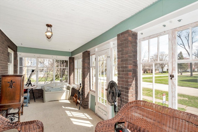sunroom featuring plenty of natural light and carpet floors