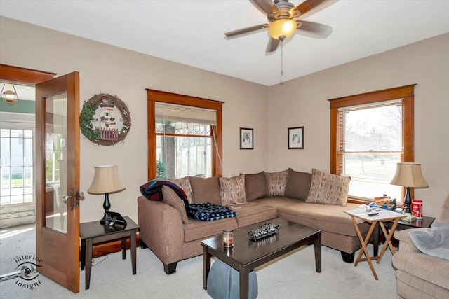 living room featuring ceiling fan and light carpet