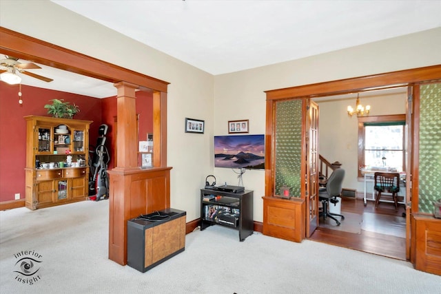 carpeted office featuring baseboards and ceiling fan with notable chandelier