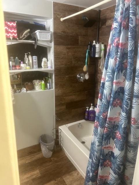 bathroom featuring shower / bathtub combination with curtain and wood finished floors