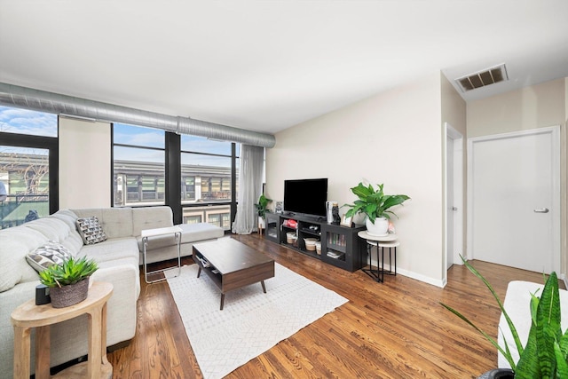 1070 W 15th St Unit 403, Chicago, IL 60608 - living area featuring plenty of natural light, wood finished floors, and baseboards