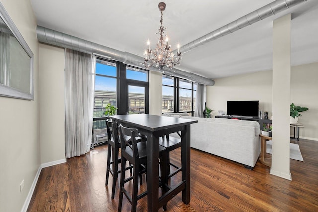 1070 W 15th St Unit 403, Chicago, IL 60608 - dining room featuring a chandelier, dark wood-style flooring, and baseboards