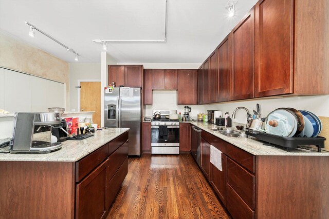 1070 W 15th St Unit 403, Chicago, IL 60608 - kitchen with appliances with stainless steel finishes, a sink, dark wood finished floors, light stone countertops, and track lighting
