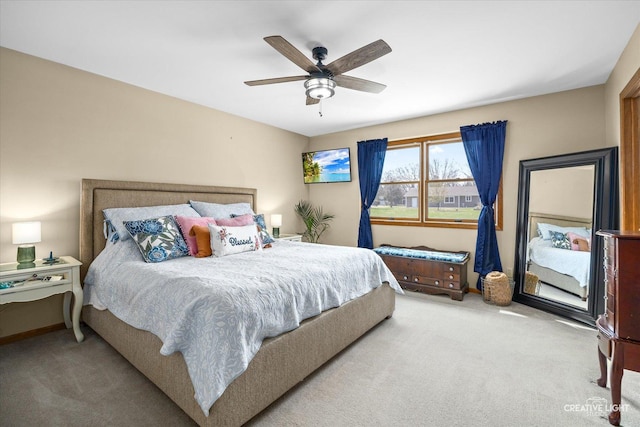 carpeted bedroom featuring baseboards and a ceiling fan