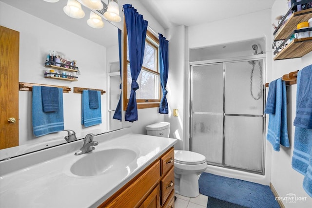 full bathroom featuring toilet, vanity, tile patterned floors, and a stall shower