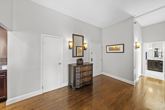 interior space featuring wood-type flooring and baseboards