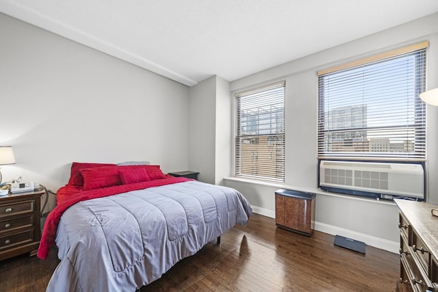 bedroom featuring cooling unit, dark wood-type flooring, and baseboards