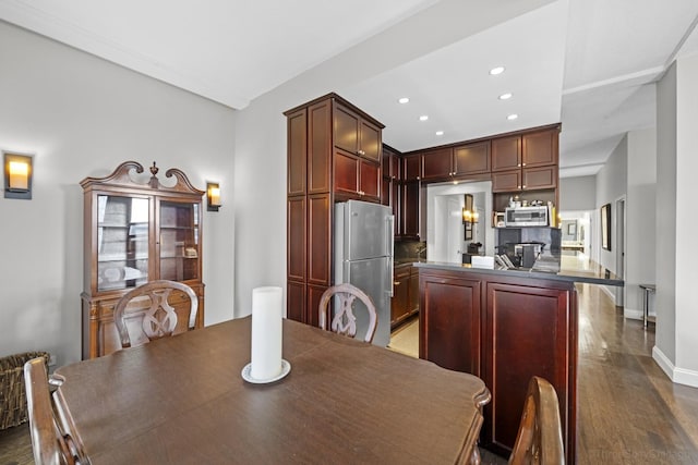 dining space with baseboards, recessed lighting, and dark wood finished floors