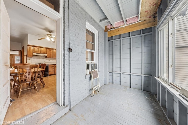sunroom featuring beamed ceiling