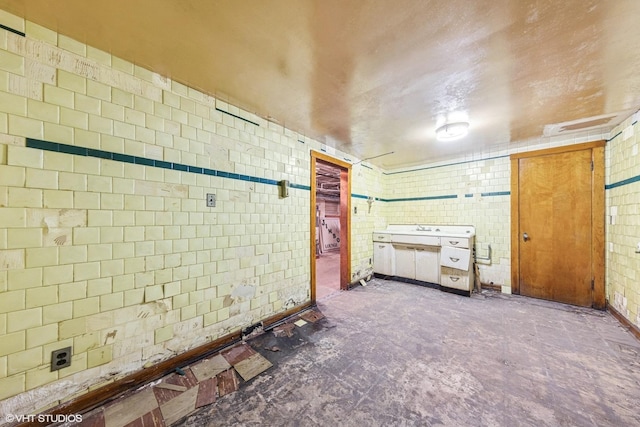 unfurnished bedroom featuring tile walls