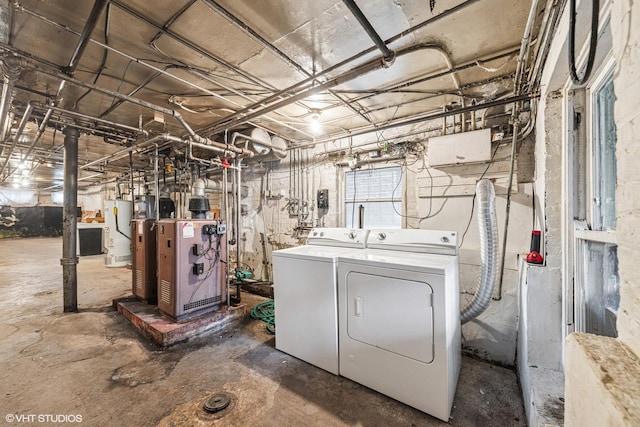 laundry room featuring separate washer and dryer, a heating unit, gas water heater, and laundry area