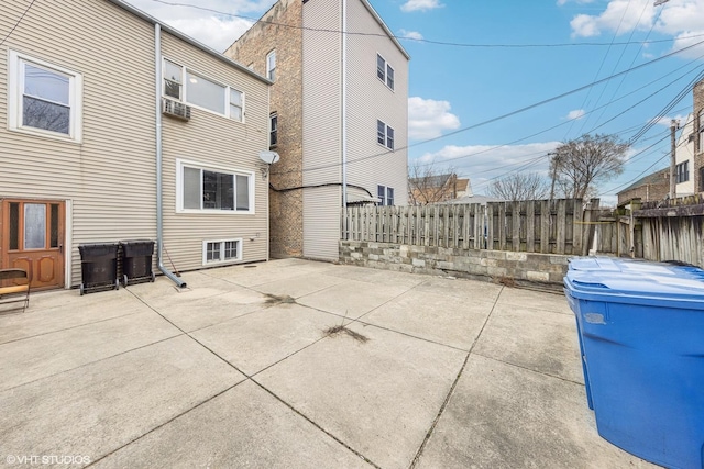 view of side of home featuring fence and a patio