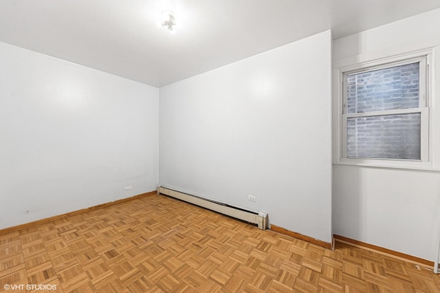 empty room featuring a baseboard radiator and baseboards