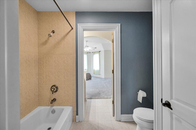 full bath featuring tile patterned floors, ceiling fan, shower / washtub combination, baseboards, and toilet