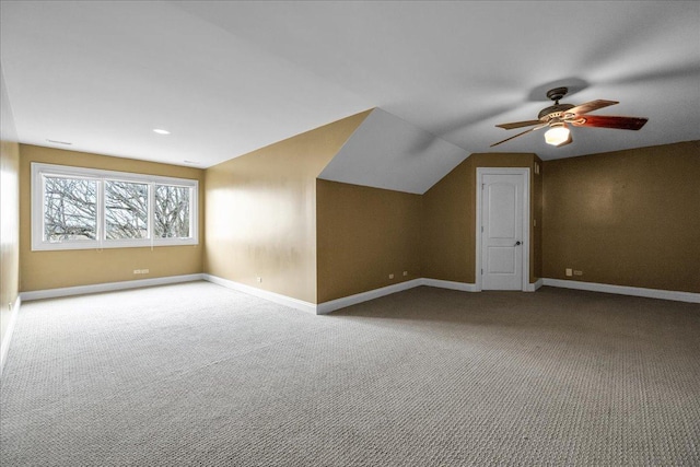 additional living space featuring a ceiling fan, baseboards, and carpet floors