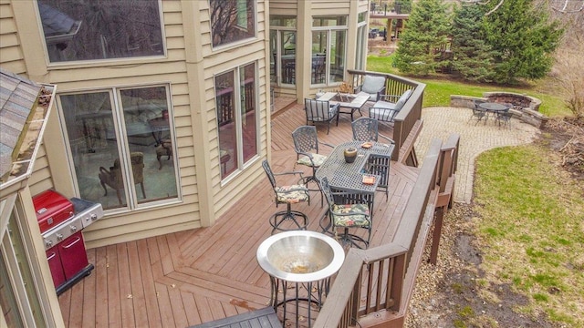 deck with an outdoor fire pit and outdoor dining space