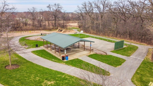 surrounding community featuring a yard, a playground, and fence