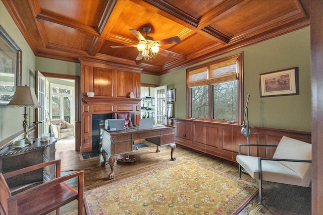office with a ceiling fan, wood finished floors, wooden ceiling, coffered ceiling, and ornamental molding