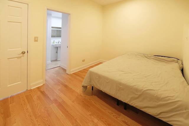 bedroom featuring baseboards and light wood-style floors