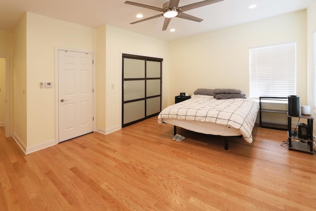 bedroom featuring baseboards, ceiling fan, light wood-style flooring, and recessed lighting