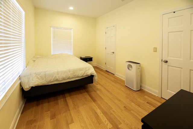 bedroom featuring recessed lighting, baseboards, and light wood-type flooring