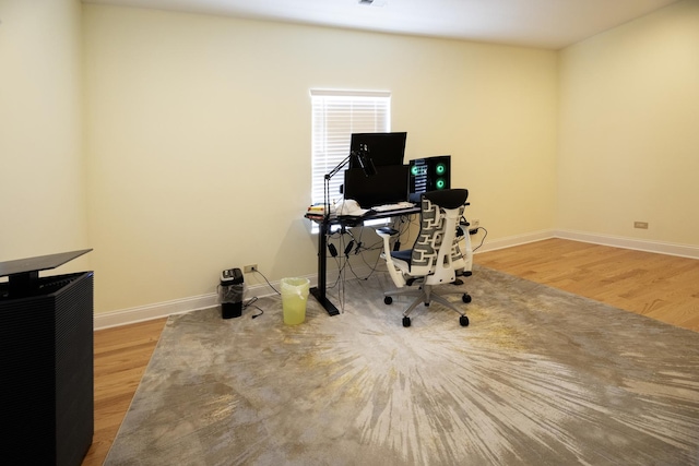 office featuring baseboards, visible vents, and wood finished floors