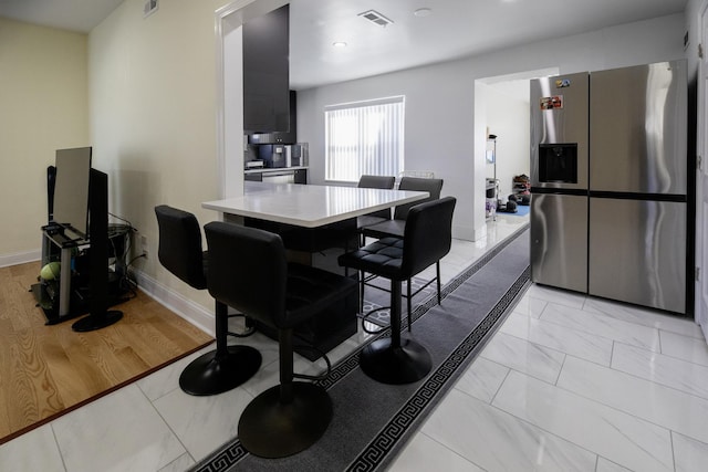 dining space with baseboards and visible vents
